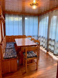 a dining room on a boat with a table and chairs at Villaggio Turistico Camping Cervino in Antey-Saint-André