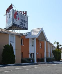 a building with a sign for the hotel miles club at Hotel Formule Club in Cenon