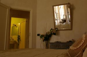 a bedroom with a bed and a mirror and a sink at Serapo Bed and Breakfast in Gaeta