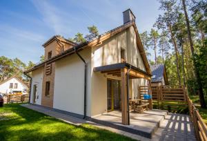 a small house with a porch and a patio at Villa Arkadia in Łukęcin