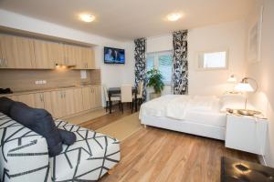 a bedroom with a bed and a table and a couch at Bled Apartments in Bled