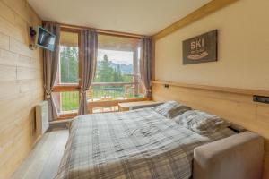 Cama ou camas em um quarto em Grand Arbois, les Arcs 1800