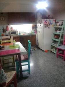 a kitchen with a white refrigerator and a table and a table at Mi Lugar en el Mundo in Buenos Aires