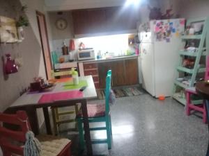 a kitchen with a table and a refrigerator at Mi Lugar en el Mundo in Buenos Aires