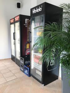 a black refrigerator with a bottle of alcohol in it at Blue Doors Hostel KTV in Rostock