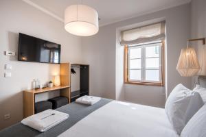 A bed or beds in a room at Urbano FLH Hotels Lisboa