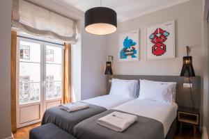 A bed or beds in a room at Urbano FLH Hotels Lisboa