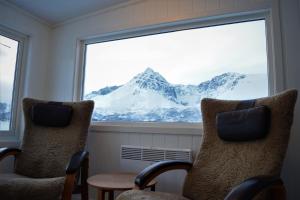 a view of a mountain through a window at Captains Small House in Hamneide