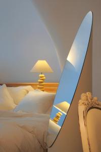 a surfboard sitting next to a bed at White Santorini in Imerovigli