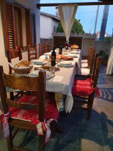 a long table with food and bottles of wine on it at B&B Perdalonga in Ghilarza