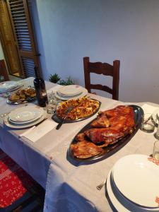 a table with a turkey and plates of food on it at B&B Perdalonga in Ghilarza