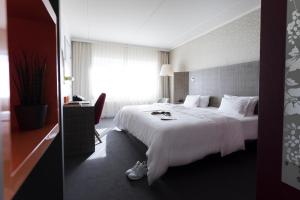 Una cama o camas en una habitación de pentahotel Eisenach