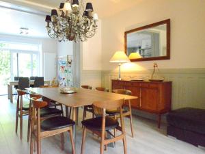 a dining room with a table and chairs and a mirror at Large townhouse with pool table in Bouillon