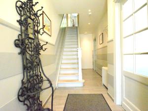 a hallway with a spiral staircase in a house at Large townhouse with pool table in Bouillon