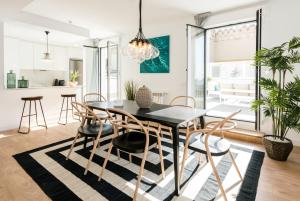 a dining room with a black table and chairs at Plaza de España Skyline in Madrid