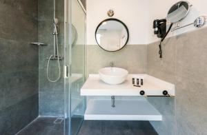 a bathroom with a sink and a shower at Plaza de España Skyline in Madrid