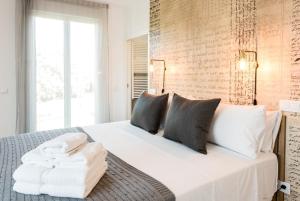 a bedroom with a large white bed with pillows at Plaza de España Skyline in Madrid