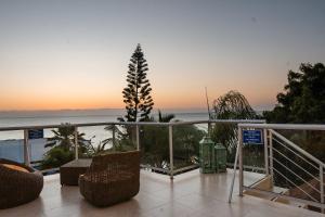 a balcony with a view of the ocean at sunset at Hotel Vistalmar in Manta