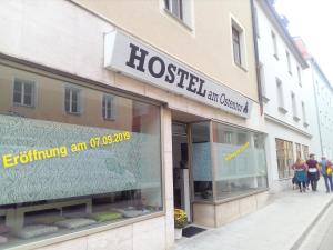 a store front of a building with people walking outside at Hostel am Ostentor in Regensburg