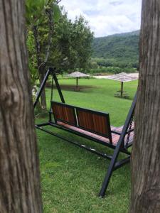 um balanço na relva com guarda-chuvas num campo em Samerdrow Khao Yai em Mu Si