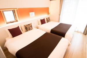 Apartment Hotel Tenjin TUMUGU 객실 침대