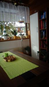 a table with a plate of food on a green table cloth at Haus Bergkristall in Längenfeld