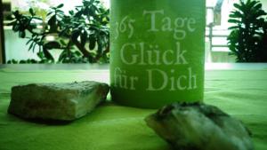 a piece of bread sitting next to a green cup at Haus Bergkristall in Längenfeld