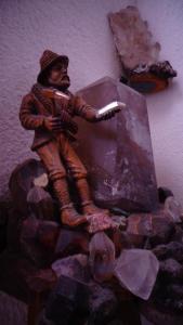 a statue of a man sitting on top of a box at Haus Bergkristall in Längenfeld