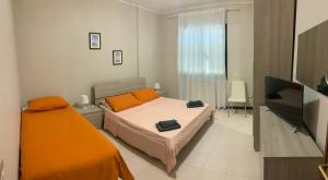 a bedroom with a bed and a flat screen tv at 32 in Ciampino