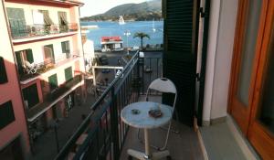 a balcony with a table and a view of the water at Affittacamere Vista Mare in Porto Azzurro