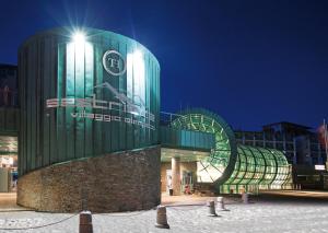 a building with a sign on the side of it at TH Sestriere - Villaggio Olimpico in Sestriere