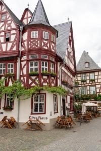 un edificio con tavoli e sedie di fronte ad esso di Altkölnischer Hof a Bacharach