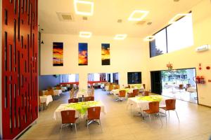 a dining room with white tables and chairs at Travelodge Kasane in Kasane