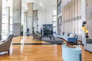 a lobby with couches and chairs in a building at Algarve Race Resort - Hotel in Montes de Cima