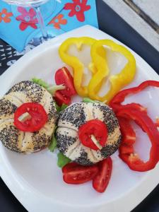 a plate of food with sesame seeded sandwiches and peppers at Hotel Madalù in Rimini