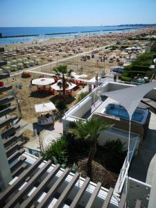 a view of the beach from a balcony of a resort at Hotel Madalù in Rimini