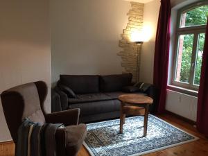 uma sala de estar com um sofá e uma mesa em Ferienwohnung Huttenstraße Halle em Halle an der Saale