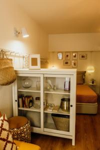 a white cabinet in a room with a bed at Amoreira in Setúbal