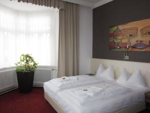 Postel nebo postele na pokoji v ubytování Stadthotel Hauser Eck