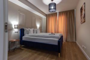 Кровать или кровати в номере Ares ApartHotel