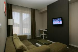 A television and/or entertainment centre at Hotel EMPIRE