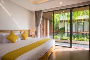 Giường trong phòng chung tại MaiChi Villa Hoi An