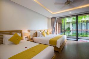 Giường trong phòng chung tại MaiChi Villa Hoi An