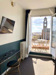 Zimmer mit einem Schreibtisch und einem Fenster mit Aussicht in der Unterkunft Hotel Saint Louis in Brest