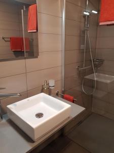 bagno con lavandino bianco e doccia di Anstatthotel Schafisheim - self-check-in a Schafisheim