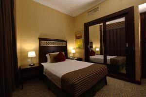 A bed or beds in a room at Concorde Hotel - Fujairah