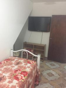 a bedroom with a bed and a flat screen tv at Departamento Libertad in San Salvador de Jujuy