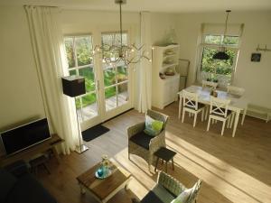 an aerial view of a living room and dining room at Luxe vakantiewoning Zeeduinsepoort met Sauna in Oostkapelle