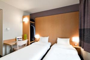 Posteľ alebo postele v izbe v ubytovaní B&B HOTEL Lyon Sud États-Unis