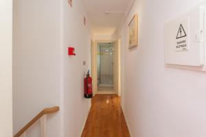 a hallway with a fire extinguisher on the wall at MouraLua in Sintra